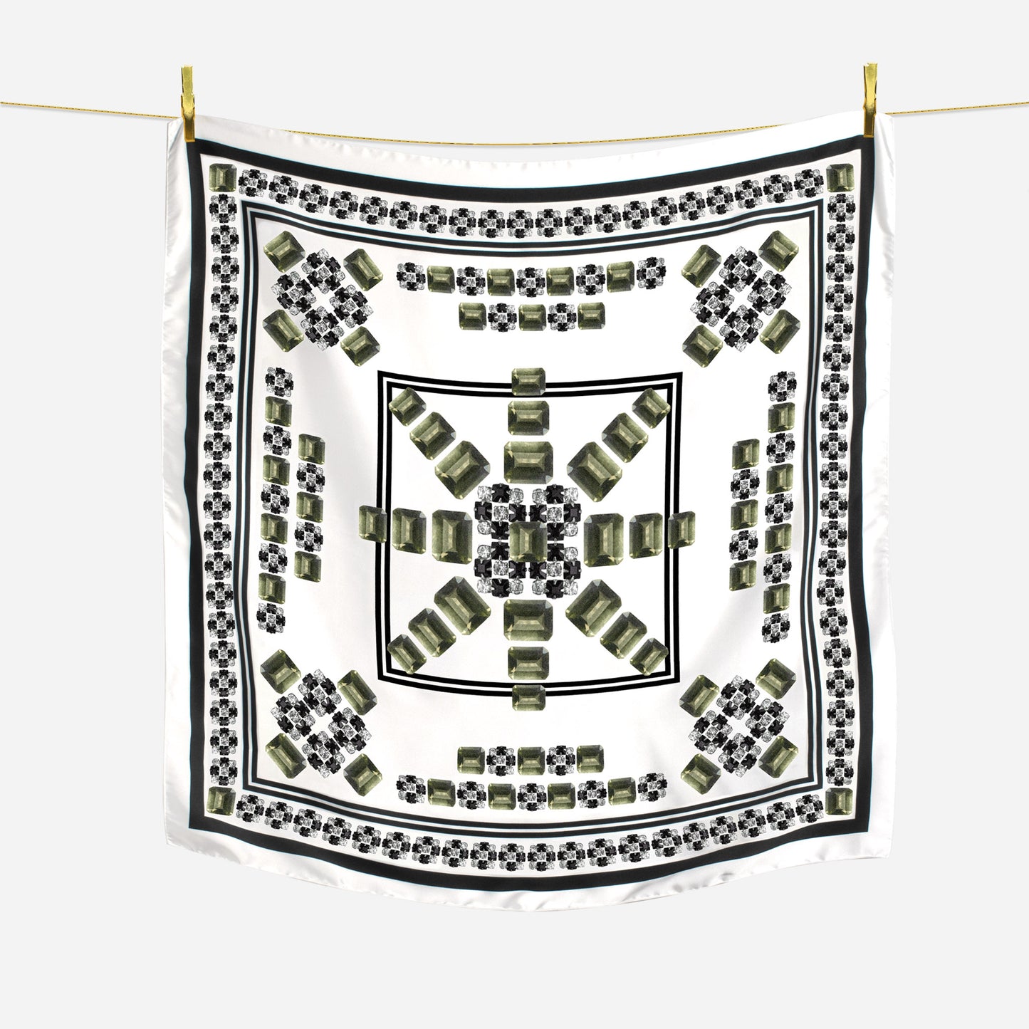 black white and moldavite gem sunburst geometric design scarf hanging on wire with gold pins