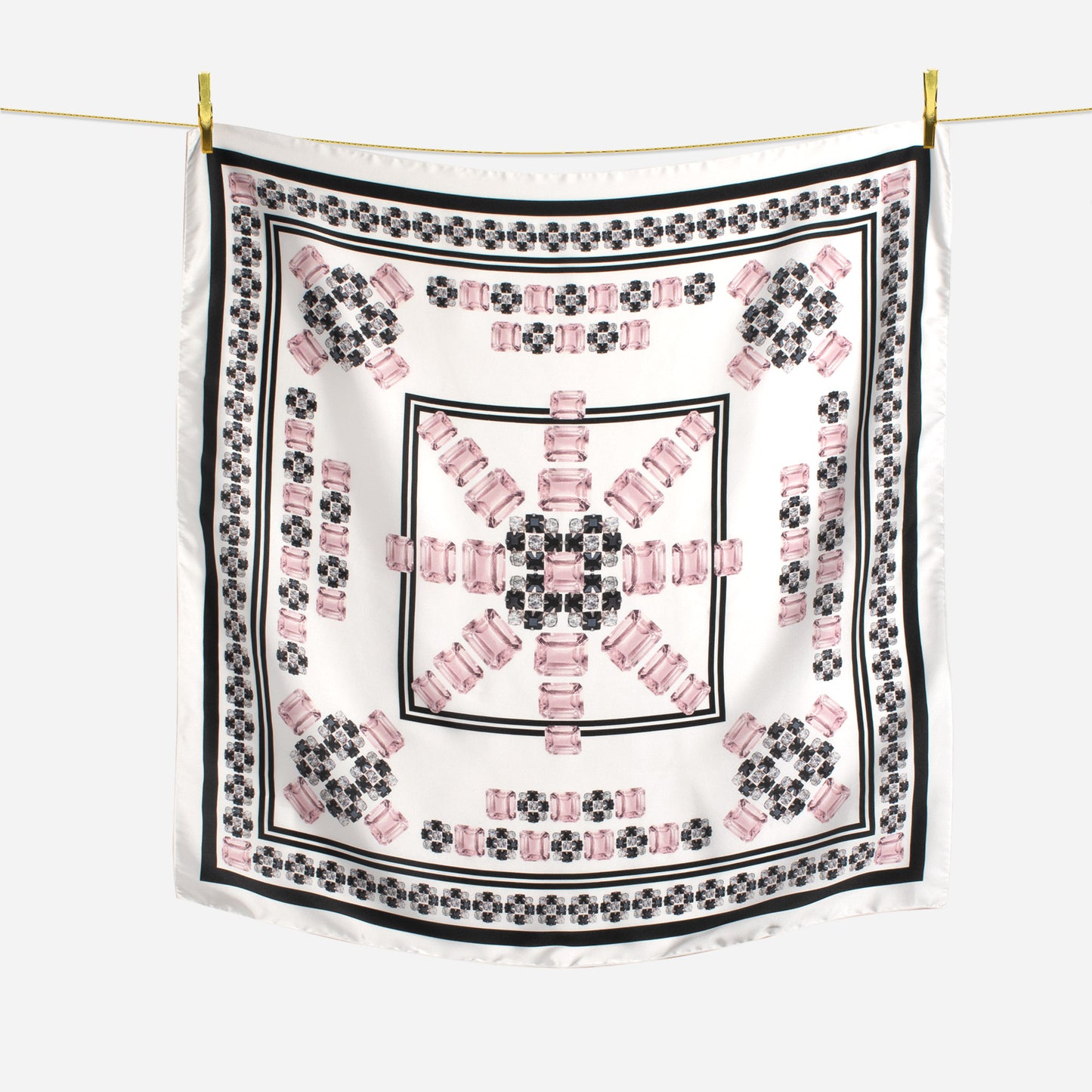 black white and morganite gem sunburst geometric design scarf hanging on wire with gold pins